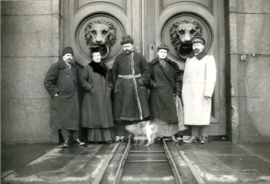 Five people in front of the entrance gate of the so-called 